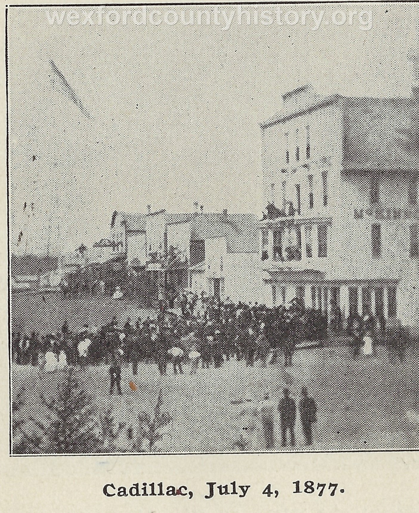 Cadillac-Parade-1877-07-04-Parade-in-front-of-McKinnon-Hotel-1