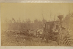 Cadillac-Lumber-Engine-Pulling-Nine-Cars-Of-Logs-With-Children-Posed-On-Cow-Catcher
