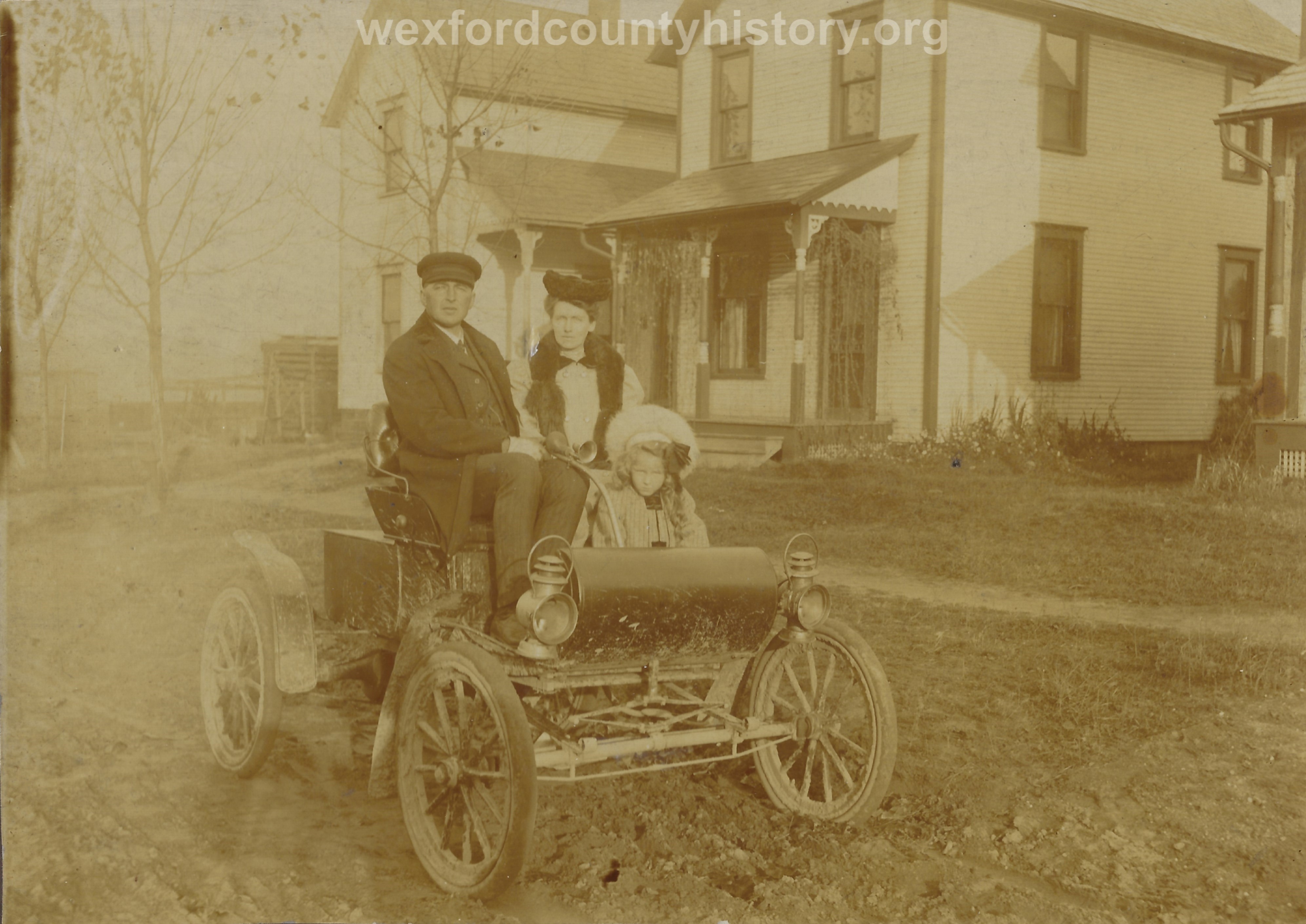Family In An Early Car